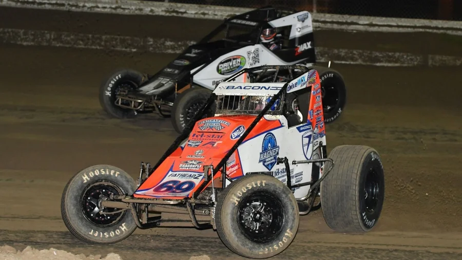 Brady Bacon (#69) passes Emerson Axsom (#47BC) for the lead and the win during Thursday night's USAC AMSOIL Sprint Car National Championship season opener at Florida's Bubba Raceway Park. Chad Warner Photo