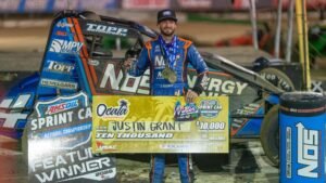 Justin Grant holds the $10,000 check after winning Saturday night's USAC Winter Dirt Games Presented by Yokohama Tire finale at Florida's Ocala Speedway. (Dave Olson Photo)